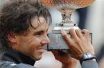 Rafael Nadal of Spain holds the trophy with the inscription of his six previous titles after winning the mens final match against Novak Djokovic of Serbia at the French Open tennis tournament in Roland Garros stadium in Paris, Monday June 11, 2012. Rain suspended the final making it the first French Open not to end on Sunday since 1973. Nadal clinched his seventh title in four sets 6-4, 6-3, 2-6, 7-5, passing Sweden's Bjorn Borg as the all-time record-holder for French Open titles.