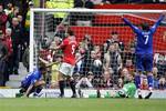 Everton's Steven Pienaar, left, celebrates after scoring past Manchester United's goalkeeper David De Gea, bottom center right, during their English Premier League soccer match at Old Trafford Stadium, Manchester, England, Sunday, April 22, 2012.