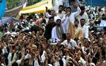 Jammu Kashmir Liberation Front (JKLF) chairman Muhammad Yasin Malik (L) along with chairman of moderate faction of All Parties Hurriyat Conference (APHC) Mirwaiz Umar Farooq join hands as thye lead an anti-India rally in downtown Srinagar on September 10, 2010. Both the leaders while addressing the Friday congregation at the historic Jamia Masjid said that they would share a common platform from today onwards and vowed to take the ongoing movement to its logical end.