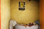 A child sleeps in a bedroom of a home with no water nor electricity in the Limpopo province town of Lebowakgomo, South Africa, Friday Feb. 3, 2012.