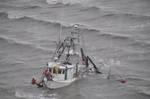 INTERCOASTAL CITY, La. - A rescue swimmer for Coast Guard Air Station New Orleans responds to the Captain Kap, a 48-foot commercial shrimper, that ran hard aground with two men aboard 600 yards offshore in Freshwater Bayou, Feb. 13, 2012. Rescued were two men who reported no medical concerns. U.S. Coast Guard photo. (1532585) ( Air Station New Orleans rescues 2 from shrimper taking on water )