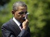 President Barack Obama wipes sweat from his face after speaking at the Memorial Day ceremony at the Vietnam Veterans Memorial Wall to commemorate the 50th anniversary of the Vietnam War, Monday, May 28, 2012, in Washington.