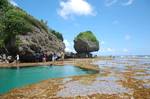 A crystal clear paradise-like saltwaterlagoon is formed by a receded sea shore and other rock formations - siargao - philippines