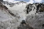 Border road organisation vehicle passes through the snow-cleared Srinagar-Leh highway on April 02, 2012