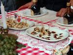 Parmigiano-Reggiano being taste tested at a festival in Modena with balsamic vinegar drizzled on top