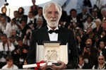 Austrian director Michael Haneke with the Palme d'Or award for the film 'The White Ribbon' during the awards ceremony during the 62nd International film festival in Cannes, southern France, Sunday, May 24, 2009.