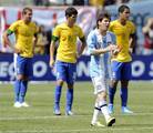 Argentina's Lionel Messi reacts after scoring a goal as Brazil's Bruno Uvino (13), Oscar (10) and Romulo (8) look on during the first half of an international friendly soccer match Saturday, June 9, 2012, in East Rutherford, N.J.