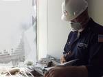 NEW YORK, NY (Sept. 17)--U.S. Coast Guard Petty Officer Tom Telehaney notes the air quality on the 20th floor of the World Financial Center Building two Sept. 17. The U.S. Coast Guard and the EPA are ensuring the air is safe for workers to return for their belongings. USCG photo by PA2 Tom Sperduto (118520) ( AIR CHECK IN NEW YORK (FOR RELEASE) )