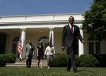 President Barack Obama, followed by from left, Transportation Secretary Ray LaHood, White House energy czar Carol Browner and EPA Administrator Lisa Jackson, walks from the Oval Office to the Rose Garden of the White House in Washington, Friday, May 21, 2010, to sign a Presidential Memorandum outlining the next steps for cleaner and more efficient vehicles.