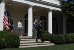 President Barack Obama, followed by, from left, White House energy czar Carol Browner, and EPA Administrator Lisa Jackson, walks from the Oval Office to Rose Garden of the White House in Washington, Friday, May 21, 2010, to sign a presidential memorandum outlining the next steps of cleaner and more efficient vehicles.