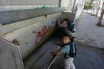 Palestinian students drink water from a public tap in the United Nations Relief and Works Agency (UNRWA) headquarters in Rafah refugee camp in the southern of Gaza Strip on November 02, 2011. The United States cut its funding to the UN's cultural arm after a majority of member states defied American and Israeli warnings and voted to allow jubilant Palestinians full membership in the organisation. PHOTO BY AHMED DEEB/WN