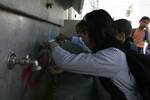 Palestinian students drink water from a public tap in the United Nations Relief and Works Agency (UNRWA) headquarters in Rafah refugee camp in the southern of Gaza Strip on November 02, 2011. The United States cut its funding to the UN's cultural arm after a majority of member states defied American and Israeli warnings and voted to allow jubilant Palestinians full membership in the organisation. PHOTO BY AHMED DEEB/WN