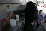 Palestinian students drink water from a public tap in the United Nations Relief and Works Agency (UNRWA) headquarters in Rafah refugee camp in the southern of Gaza Strip on November 02, 2011. The United States cut its funding to the UN's cultural arm after a majority of member states defied American and Israeli warnings and voted to allow jubilant Palestinians full membership in the organisation. PHOTO BY AHMED DEEB/WN