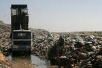 A Palestinian man collect recycling materials next to the animals of carrion from the Gaza Strip's main garbage dump Barrier of the 