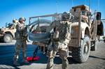 Spc. Craig Moon and fellow paratrooper with the 82nd Airborne Division’s 1st Brigade Combat Team load concertina wire onto the front of a Mine Resistant Ambush Protected vehicle after using it to make a temporary traffic control point to search vehicles in a partnered U.S. Afghan clearing operation April 29, 2012, Ghazni province, Afghanistan. Military vehicles often travel with rolls of the wire fastened to their exteriors for just this purpose. (U.S. Army photo by Sgt. Michael J. MacLeod)