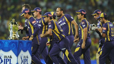 Cricketers Kolkata Knight Riders runs past the DLF IPL trophy prior to the IPL Twenty20 cricket final match between Chennai Super Kings and Kolkata Knight Riders at The M.A.Chidambaram Stadium in Chennai on May 27, 2012