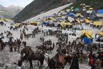 Kashmiri Muslim pony owners wait on the snow for Hindu pilgrims to carry them back to the base camp near Amarnath cave, one of the most revered of Hindu shrines on July 01, 2011. near Baltal, Jammu and Kashmir, India. More than 5,000 Hindu devotees, braving sub-zero temperatures, began the hike over glaciers and along paths overhanging gorges to reach the sacred Amarnath cave housing an ice stalagmite, a stylized phallus worshiped by Hindus as a symbol of the god Shiva, enveloped by the rugged H