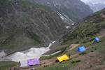 Thousands of tents are installed for Hindu pilgrims during Amarnath Pilgrimage, one of the most revered of Hindu shrines on July 01, 2011. near Baltal, Jammu and Kashmir, India. More than 5,000 Hindu devotees, braving sub-zero temperatures, began the hike over glaciers and along paths overhanging gorges to reach the sacred Amarnath cave housing an ice stalagmite, a stylized phallus worshiped by Hindus as a symbol of the god Shiva, enveloped by the rugged Himalayan mountains. The Kashmiri mountai