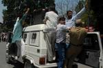 India policemen detain Kashmiri government employees during a march to Raj Bhawan while riot police unleash purple-dyed water cannon to disperse a protest in Srinagar on June 16, 2012. Indian police used water cannons and detained dozens of state government employees demanding an increase in the retirement age from 58 to 60 and the release of their arrears.