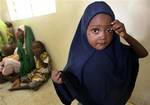 Niima Ahmed who is a polio sufferer stands as she and other polio suffering children wait to see a doctor at the General hospital in Kano, Nigeria Thursday, July 19, 2007. New York-based Pfizer is facing four court cases two filed by the federal government , two by the state in Nigeria over a decade-old drug trial in the northern Muslim city of Kano. It is accused of using a 1996 meningitis epidemic to push through a sloppily managed study without the full understanding of the parents or the pro