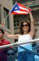 Jennifer Lopez holding the Puerto Rico flag, in September 2009