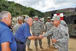 Puerto Rico Army National Guard Brig. Gen. Victor Perez, right, the director of the joint staff, greets civil authorities and U.S. Soldiers with the 130th Engineer Battalion and Alpha Company, 296 Infantry, 2-65th Infantry Battalion while surveying damage caused by mudslides in Utuado, Puerto Rico, March 31, 2012. (U.S. Army photo by Pfc. Eliezer Melendez/Released)