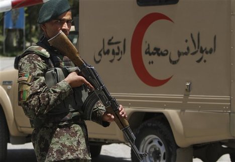 File - An Afghan National Army soldier patrols the gate of the military hospital next to an ambulance in Kabul, Afghanistan, Sunday, May 13, 2012. 2012.