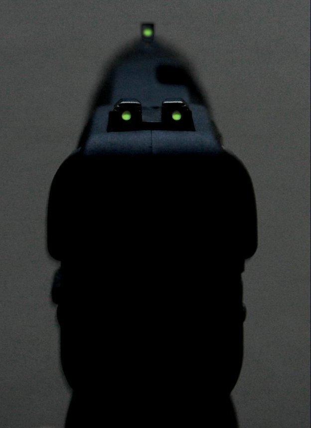 Photo of tritium-illuminated Five-seven USG iron sights in dim lighting