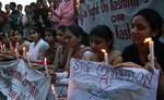 A group of Kashmiri students hold candles as they stage a symbolic protest against corruption on the banks of Dal Lake in Srinagar, the summer capital of Indian Kashmir, 15 May 2012. Protesters comprised of students from medicine, journalism, law and social science. Corruption in India has been at the forefront of the debate as the parliament in last session tried to pass an anti-corruption bill, but failed to pass it as the legislators couldn't develop a consensus over the issue.