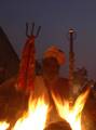 An Indian Sadhu - Hindu holy man - warms himself at a fire at a temporary camp in Kolkata, 09 January 2008. Thousands of Hindu pilgrims have started to converge for the Gangasagar Mela which will culminate on 14 January, on the occasion of Makar Sankranti, a holy day of the Hindu calendar, during which a dip in the ocean at the confluence of the River Ganges and the Bay of Bengal, some 150 kms south of Kolkata, is considered to be of great religious significance in Eastern