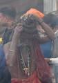 An Indian Sadhu - Hindu holy man - set his big hair at a fire at a temporary camp in Kolkata, 09 January 2008. Thousands of Hindu pilgrims have started to converge for the Gangasagar Mela which will culminate on 14 January, on the occasion of Makar Sankranti, a holy day of the Hindu calendar, during which a dip in the ocean at the confluence of the River Ganges and the Bay of Bengal, some 150 kms south of Kolkata, is considered to be of great religious significance in Eastern