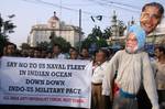 All India Anti Imperialist Forum activists prepare to burn a combined effigy representing Indian Prime Minister Manmohan Singh and US President Barack Obama during a protest rally in Kolkata on June 11, 2012. The demonstrators protested against the presence of the US naval fleet in the Indian Ocean and demanded the immediate withdrawal of the force