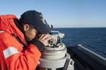 Fire Controlman 2nd Class Roger Bailey tracks the bearing of a small craft during a strait transit drill aboard the Arleigh Burke-class guided missile-destroyer USS Nitze (DDG94).