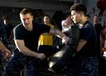 Airman Apprentice Bailey Ipock defends himself during an oleoresin capsicum (OC) qualification course on the fantail of the Nimitz-class aircraft carrier USS Abraham Lincoln (CVN 72).