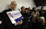 Steve Bailey, of Vets for Romney, shows his support for Republican presidential candidate, former Massachusetts Gov. Mitt Romney, has he and others listen to a speech being given by Republican presidential candidate Rep. Ron Paul, R-Texas, during a Washington state caucus meeting, Saturday, March, 3, 2012, in Puyallup, Wash. (AP Photo/Ted S. Warren)