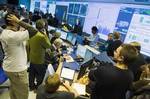 Scientists gather at the European Organisation for Nuclear Research (CERN) data quality satellite control center of the ATLAS detectors during the restart of the Large Hadron Collider (LHC) in Meyrin, near Geneva, Switzerland, Monday, Nov. 23, 2009.