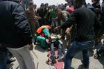 Palestinian protesters carry away a wounded demonsrator after Israeli soldiers opened fire during a massive march towards the Erez border crossing in the northern Gaza Strip on May 15, 2011 to mark the 