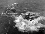 NANTUCKET, Mass., (July 2000)--The two halves of the SS Argo Merchant swirl in a sea of foam before being sucked under. The tanker broke into two pieces Dec. 21, 1976, after running aground six days earlier on its way to Salem, Mass., with a load of 7.3 million gallons of heavy industrial fuel oil. The 644-foot, 18, 743-ton Liberian-flagged tanker ran aground Dec. 15 in international waters 28 miles southeast of Nantucket Island, causing a major spill. Helicopters from Coast Guard Air Station Ca