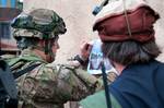 A paratrooper with the 82nd Airborne Division’s 1st Brigade Combat Team questions a villager about propaganda posted by Taliban during a patrol to capture a high-value individual Jan. 26, 2012, on the simulated battlefield of the Joint Readiness Training Center, Fort Polk, La. The propaganda warns villagers not to cooperate with Coalition Forces or the Afghan government. (U.S. Army photo by Sgt. Michael J. MacLeod)