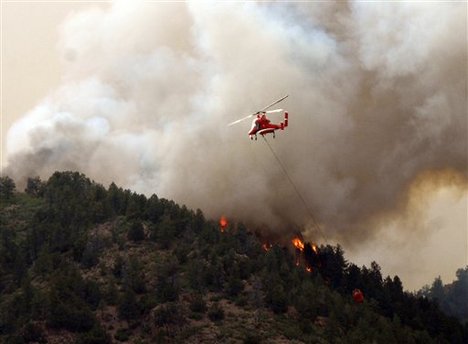 Flames of the Waldo Canyon Fire races down into western portions of Colorado Springs, Colo. on Tuesday, June 26, 2012.