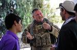 U.S. Army Lt. Col. Anthony Ulrich, a civil affairs officer for Provincial Reconstruction Team Farah, visits with his Afghan friends at the orphanage in Farah City, Farah province, Afghanistan, June 19. Ulrich and other PRT members are visiting the orphanage to deliver toys and other goods to the children.