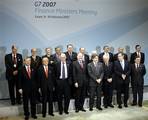 Germany´s Finance Minister Peer Steinbrueck, center, smiles as he poses with his counterparts during a group photo at the G7 Finance Ministers Meeting in Essen, Germany, Saturday, Feb.10, 2007. The finance ministers and central bankers of the world