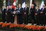 President Bush, left, makes a statement in the Rose Garden of the White House after meeting with G7 finance ministers about the financial crisis, Saturday, Oct. 11, 2008, in Washington. Seen from left to right listening are Italy's central bank governor Mario Draghi; IMF Managing Director Dominique Strauss-Kahn; Eurogroup's Chairman Jean-Claude Juncker; Japan's Finance Minister Shoichi Nakagawa; Treasury Secretary Henry Paulson; France Finance Minister Christine Lagarde; Canada Finance Minister