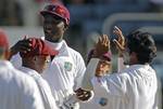 West Indies' wicket keeper Carlton Baugh, left, is congratulated by his captain Darren Sammy and bowler Devendra Bishoo for taking the catch behind the wicket to dismiss India's opener Abhinav Mukund for 25 runs in the second innings during the second day of their first cricket Test match in Kingston, Jamaica, Tuesday June 21, 2011.