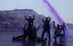 kashmiri Government employees shout anti government slogans as police spray purple colored water canon to disperse during a protest in Srinagar, the summer capital of indian kashmir 14, June 2012.