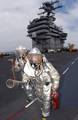 During a mass casualty drill held on flight deck aboard USS Carl Vinson (CVN 70), Airman Tory Galvis, front, and Airman Bryan Croft advance toward an aircraft fire.