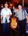 Two old-time musicians with the LoBro, a homemade, one-of-a-kind resonophonic plucked bass instrument modeled on the Dobro. Photo taken summer 1998 at the 1998 Old Fiddler's Convention in Galax, Virginia, United States.