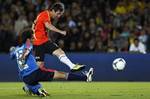 Alvaro Gonzalez, from Uruguay, challenges Argentina's Lionel Messi during a charity exhibition soccer match between Messi's Friends and the Rest of the World in Bogota, Colombia, Thursday, June 21, 2012.