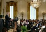 President George W. Bush welcomes guests to the East Room of the White House Friday, June 22, 2007, to join in a celebration of Black Music Month, focusing on the music of hip hop and R &B artists. White House photo by Eric Draper