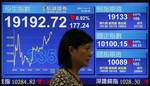 A woman walks by a screen displaying the Hong Kong stock index's movement at a stockbrokerage firm in Hong Kong Wednesday, Nov. 2, 2011. Asian stocks slumped for a third day Wednesday, as fears intensified that Greece might reject an austerity plan and default on its massive debts. Hong Kong's Hang Seng dropped 177.24 to 19,192.72 in the mid day close. (AP Photo/Vincent Yu)